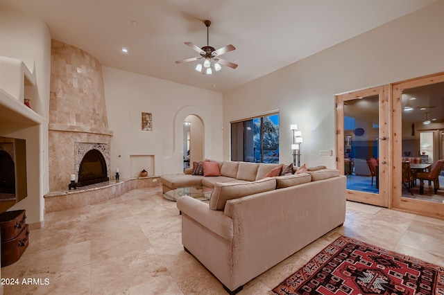 living room featuring a fireplace and ceiling fan