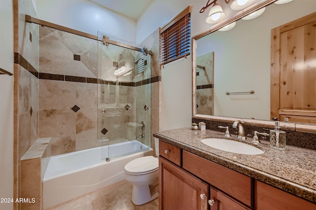 full bathroom with shower / bath combination with glass door, vanity, tile patterned flooring, and toilet