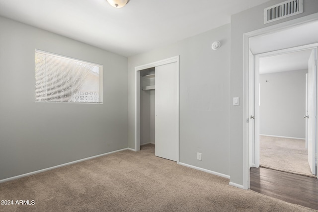 unfurnished bedroom featuring carpet and a closet