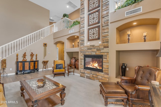 9702 E Naranja Ave, Mesa, AZ 85209 - living area featuring a high ceiling, a stone fireplace, built in features, arched walkways, and baseboards