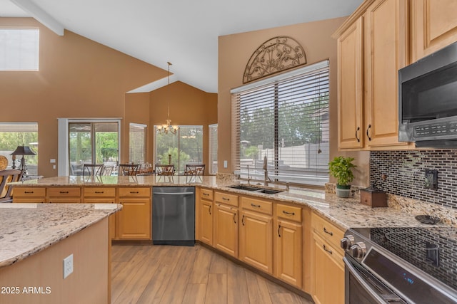 9702 E Naranja Ave, Mesa, AZ 85209 - kitchen with appliances with stainless steel finishes, a sink, light wood finished floors, a chandelier, and plenty of natural light