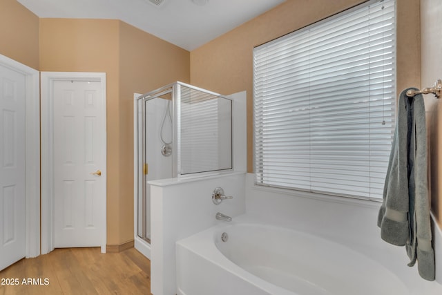 9702 E Naranja Ave, Mesa, AZ 85209 - full bath with a shower stall, a garden tub, and wood finished floors