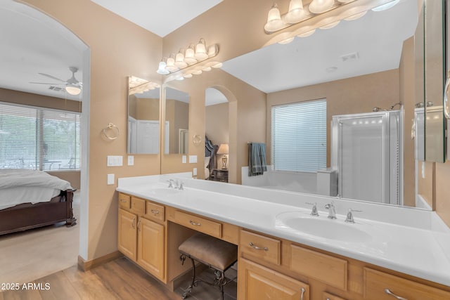 9702 E Naranja Ave, Mesa, AZ 85209 - ensuite bathroom featuring double vanity, wood finished floors, a ceiling fan, a stall shower, and baseboards