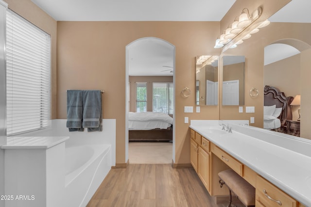 9702 E Naranja Ave, Mesa, AZ 85209 - ensuite bathroom with wood finished floors, vanity, a garden tub, and baseboards