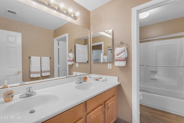 9702 E Naranja Ave, Mesa, AZ 85209 - full bath with double vanity, toilet, wood finished floors, and shower / tub combination