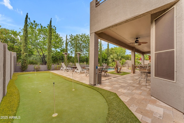 9702 E Naranja Ave, Mesa, AZ 85209 - fenced backyard featuring a putting green, ceiling fan, and a patio area