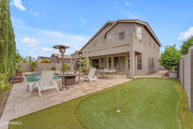 9702 E Naranja Ave, Mesa, AZ 85209 - back of house featuring a putting green, a patio area, stucco siding, and a fenced backyard