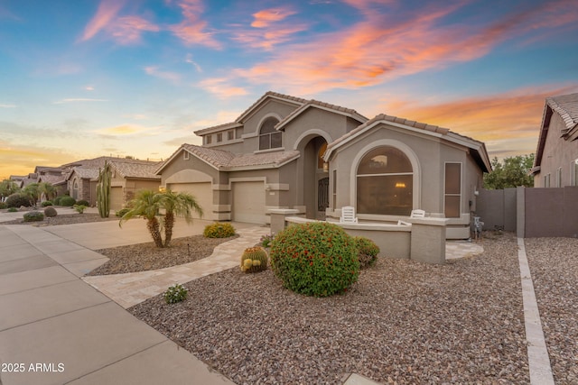 9702 E Naranja Ave, Mesa, AZ 85209 - mediterranean / spanish-style home featuring stucco siding, concrete driveway, a tiled roof, and an attached garage