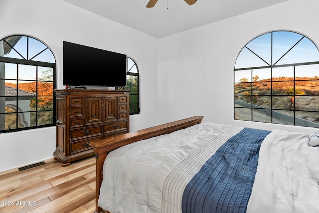 bedroom with light hardwood / wood-style flooring and ceiling fan