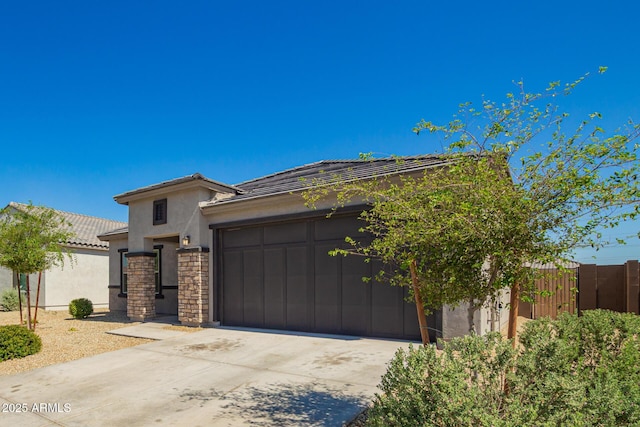 24627 W Ripple Rd, Buckeye, AZ 85326 - view of front of house with an attached garage, concrete driveway, stucco siding, and a tiled roof