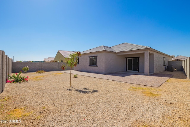 24627 W Ripple Rd, Buckeye, AZ 85326 - rear view of house featuring stucco siding, a fenced backyard, a tiled roof, and a patio area