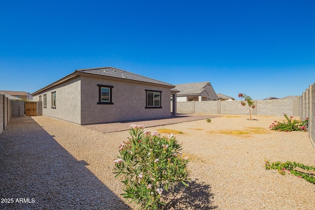 24627 W Ripple Rd, Buckeye, AZ 85326 - back of house featuring a fenced backyard, stucco siding, and a patio area