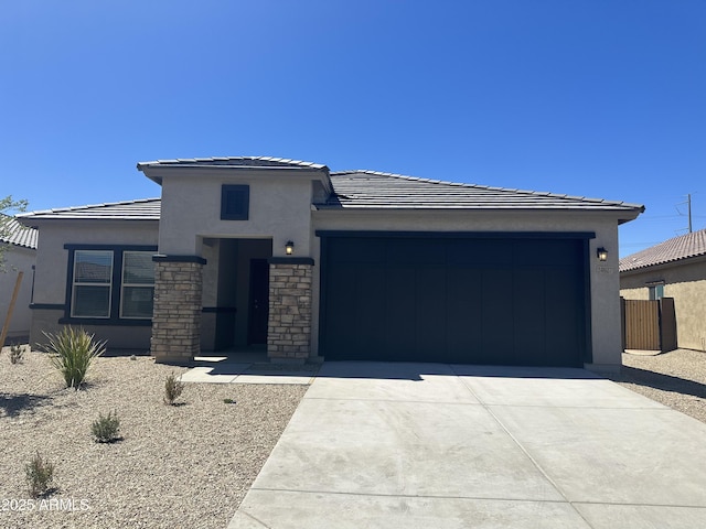 24627 W Ripple Rd, Buckeye, AZ 85326 - prairie-style house with driveway, stucco siding, a garage, a tile roof, and stone siding