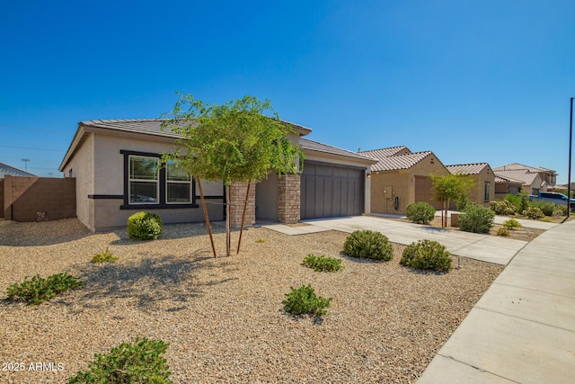 24627 W Ripple Rd, Buckeye, AZ 85326 - view of front facade with an attached garage, concrete driveway, stucco siding, and a tiled roof