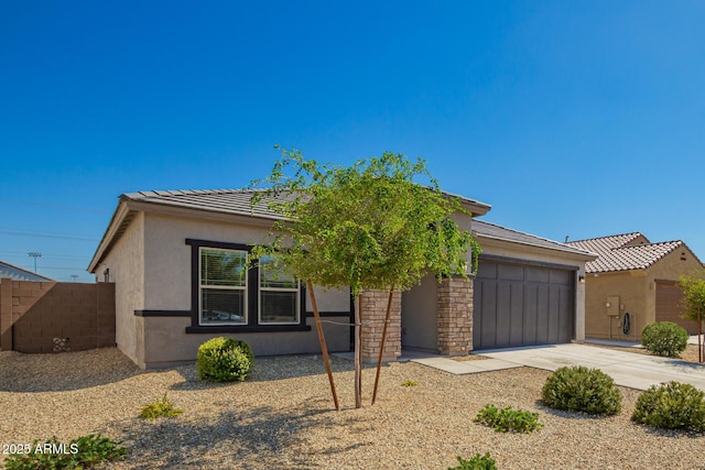 24627 W Ripple Rd, Buckeye, AZ 85326 - view of front of home featuring a garage, concrete driveway, stucco siding, and a tiled roof