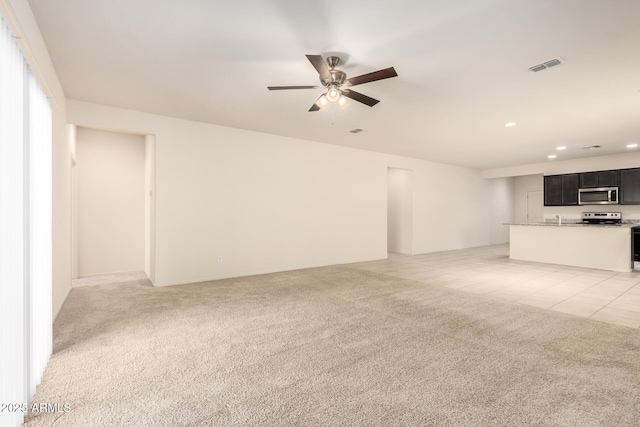 24627 W Ripple Rd, Buckeye, AZ 85326 - unfurnished living room with ceiling fan, recessed lighting, and light colored carpet
