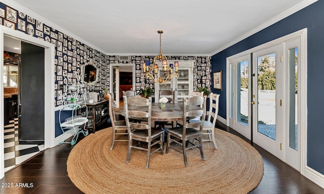 dining space featuring wood finished floors, crown molding, and french doors