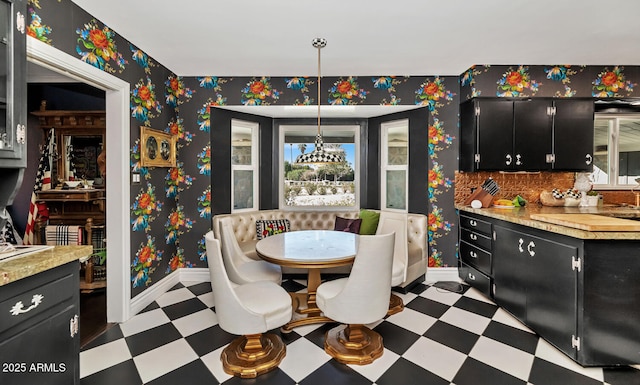 dining area with wallpapered walls, plenty of natural light, baseboards, and tile patterned floors