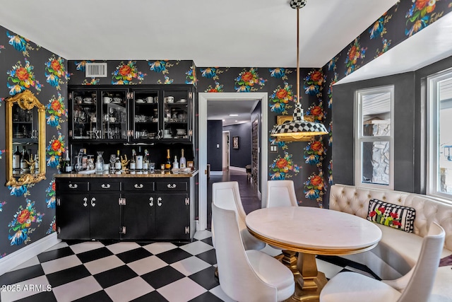 dining space featuring wallpapered walls, visible vents, a bar, and tile patterned floors