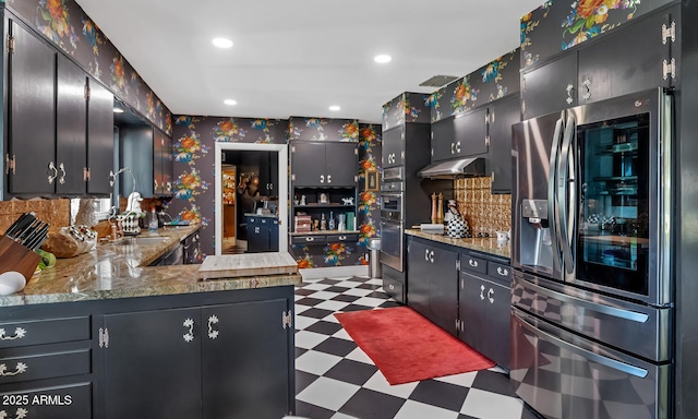 kitchen with wallpapered walls, stainless steel fridge with ice dispenser, tile patterned floors, under cabinet range hood, and a sink