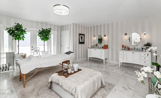 bedroom with marble finish floor, french doors, baseboards, and wallpapered walls