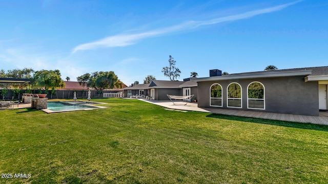 back of property featuring a yard, a patio, fence, and stucco siding