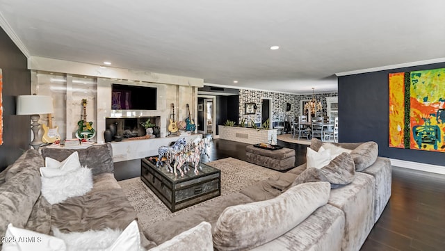 living area featuring a high end fireplace, recessed lighting, crown molding, and wood finished floors