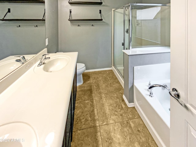 bathroom with tile patterned flooring, toilet, vanity, a shower stall, and a bath