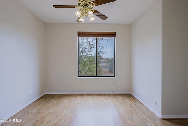 empty room with light wood-style floors, baseboards, and a ceiling fan