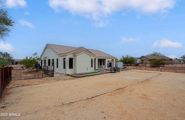 exterior space featuring a patio, a tile roof, fence private yard, and stucco siding