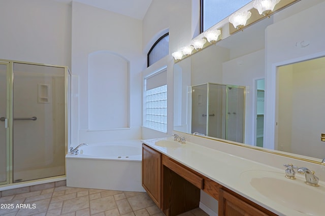 bathroom with a garden tub, a sink, a shower stall, and double vanity