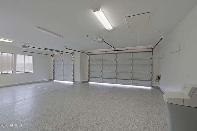 garage with a garage door opener and baseboards