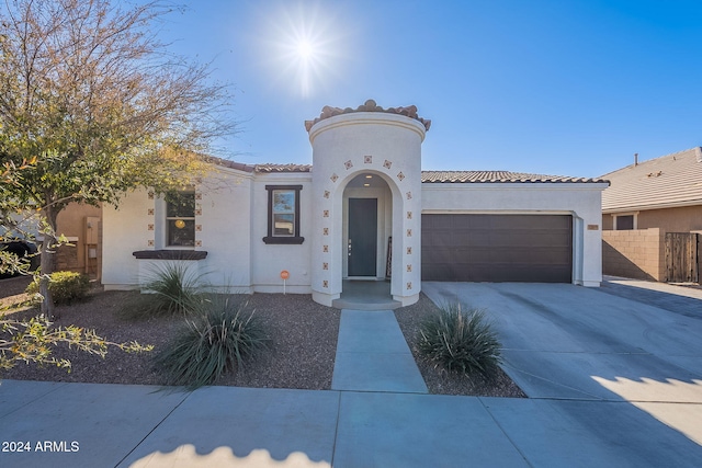 mediterranean / spanish-style home with a garage