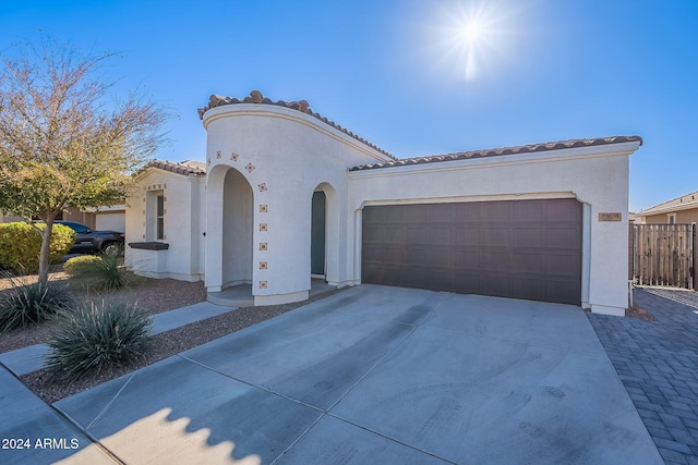 mediterranean / spanish home featuring a garage