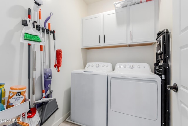 clothes washing area with cabinet space and washing machine and clothes dryer