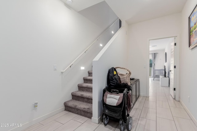 stairway featuring baseboards