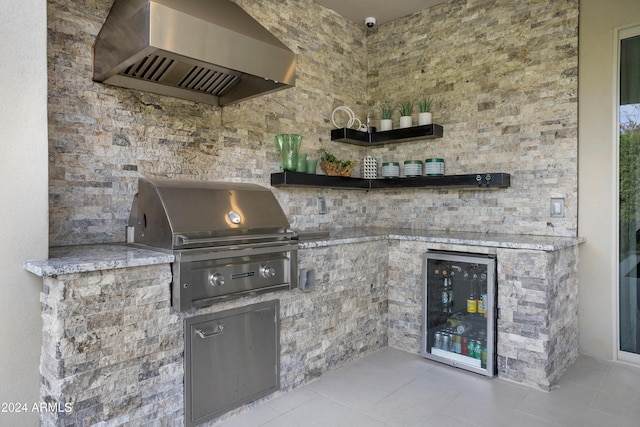 view of patio / terrace featuring a grill, exterior kitchen, and wine cooler