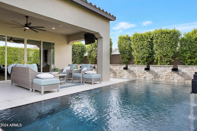 view of pool with outdoor lounge area, a patio, and ceiling fan