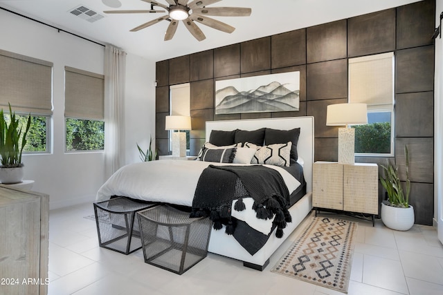 bedroom with ceiling fan and light tile patterned floors