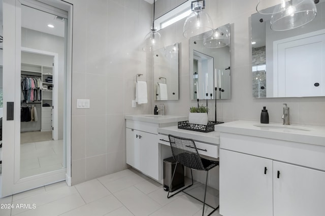 bathroom featuring tile patterned floors, vanity, and tile walls