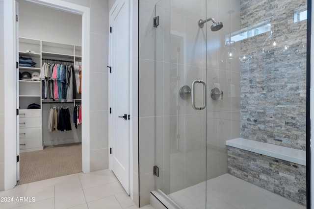 bathroom with tile patterned floors and walk in shower