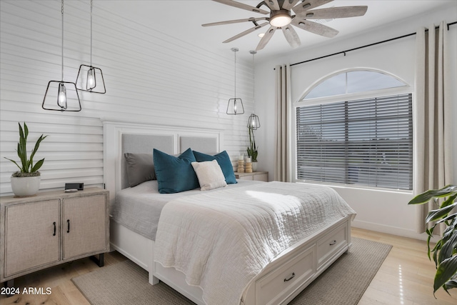 bedroom with light hardwood / wood-style flooring and ceiling fan