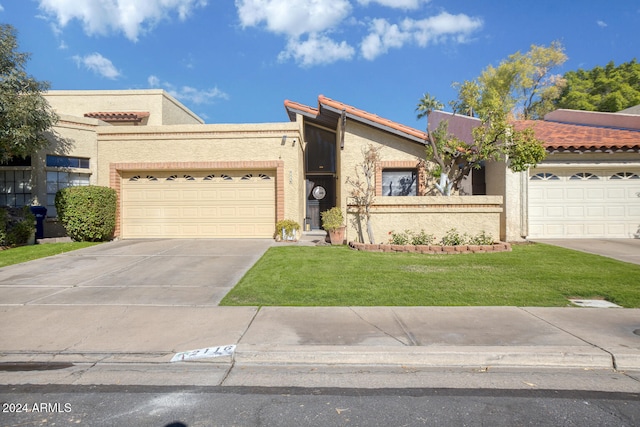 view of front of house featuring a front yard and a garage