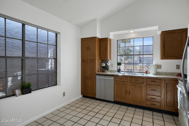 kitchen with sink, stainless steel dishwasher, white range, vaulted ceiling, and light tile patterned floors