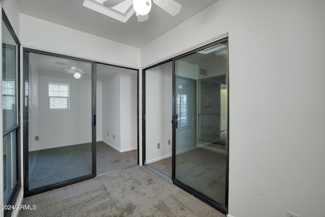 unfurnished bedroom featuring carpet flooring, a closet, and ceiling fan