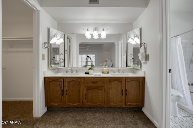 bathroom featuring vanity, toilet, and ceiling fan