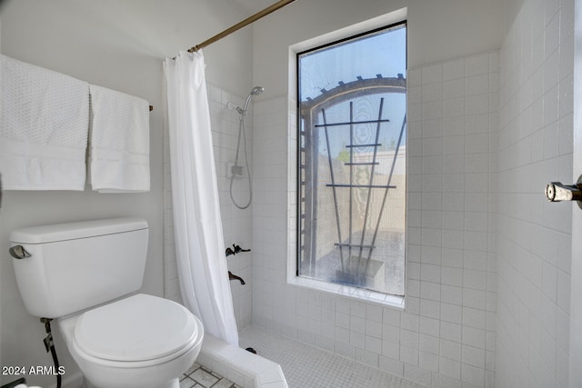 bathroom featuring tile patterned floors, toilet, and curtained shower