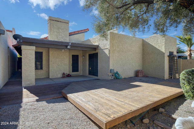 back of house featuring a wooden deck