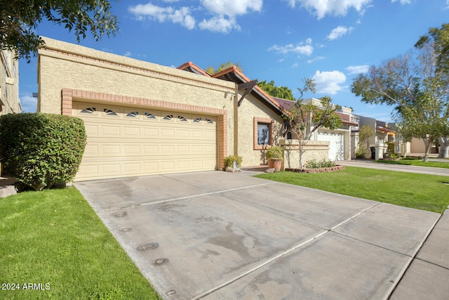 view of front facade with a front yard and a garage