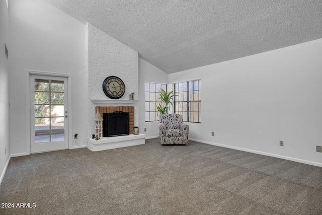 unfurnished living room with carpet floors, a textured ceiling, high vaulted ceiling, and a brick fireplace